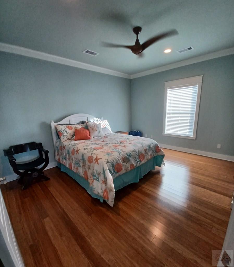 1279 Faggards Road Port Bolivar, TX 77650 - Photo 15 of 16 a bedroom with a bed and wooden floor