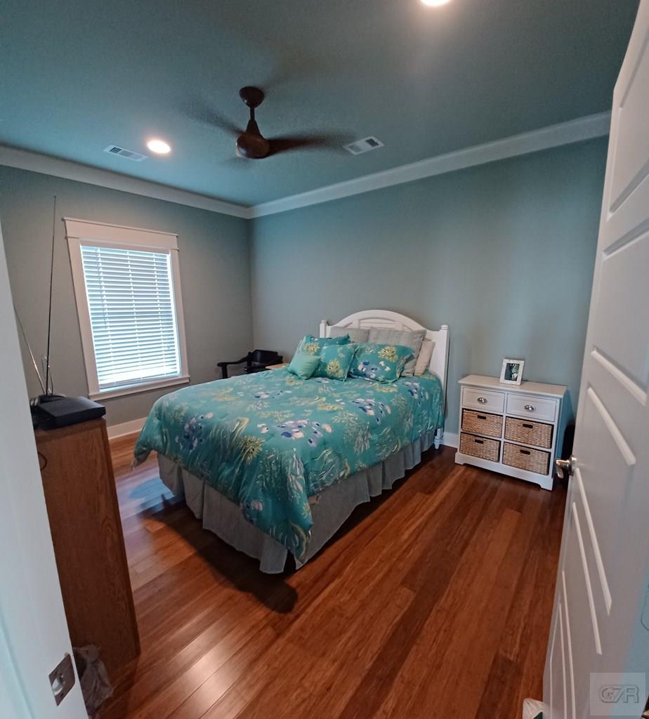 1279 Faggards Road Port Bolivar, TX 77650 - Photo 16 of 16 a bedroom with a bed and wooden floor