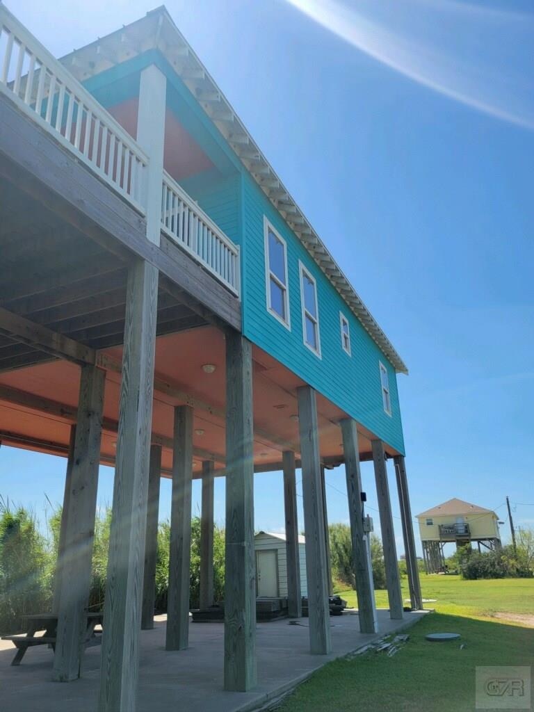 1279 Faggards Road Port Bolivar, TX 77650 - Photo 3 of 16 a front view of a building with glass door and outdoor space