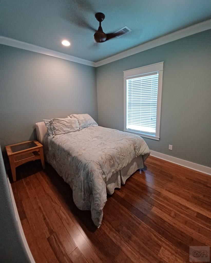 1279 Faggards Road Port Bolivar, TX 77650 - Photo 10 of 16 a bedroom with a bed and wooden floor