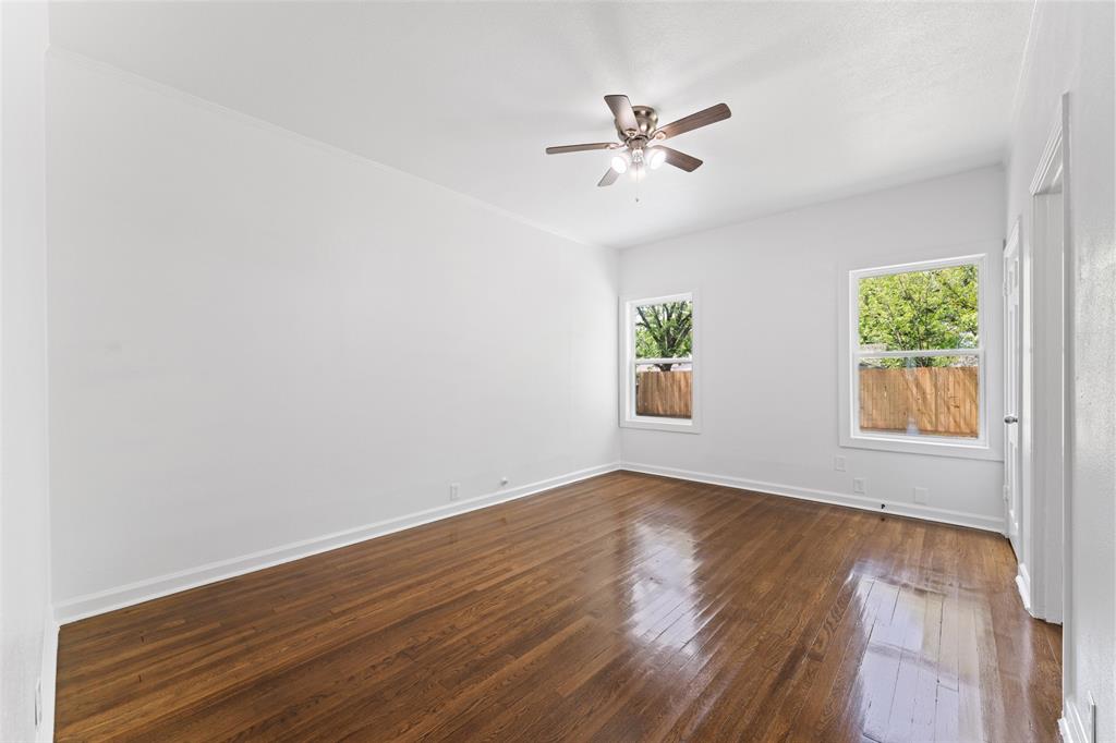 2405 Monroe Street Commerce, TX 75428 - Photo 16 of 31 a view of an empty room with wooden floor and a window