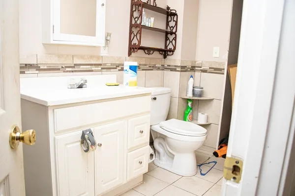 a bathroom with a sink vanity mirror and toilet