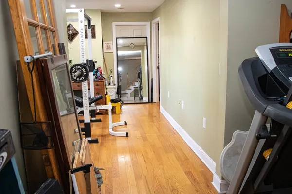 a view of a hallway with wooden floor