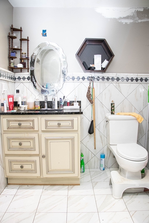 20 Washburn Street Worcester, MA 01610 - Photo 23 of 40 a bathroom with a toilet a sink and mirror