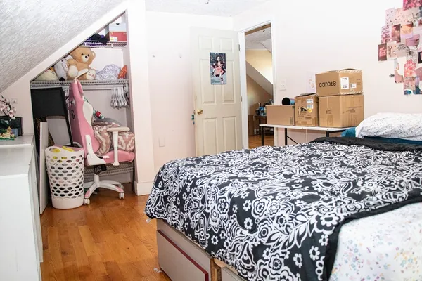 a bedroom with bed and cabinets