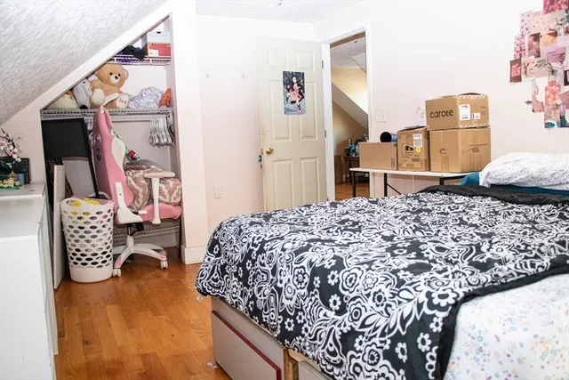 a bedroom with bed and cabinets