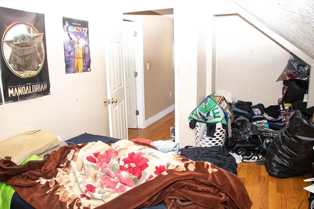 a bedroom with a bed and a chandelier