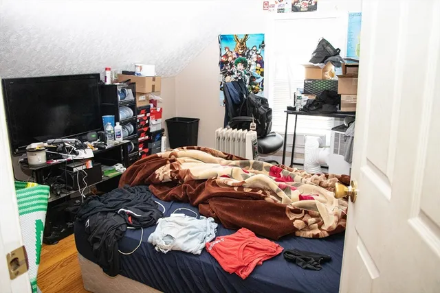 a bedroom with furniture and a flat screen tv