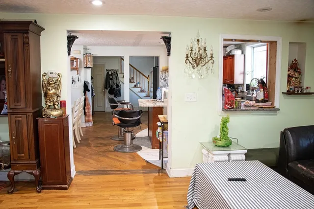 a living room with furniture a rug and a painting on the wall