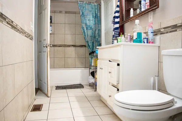 a white toilet sitting next to a bathroom sink