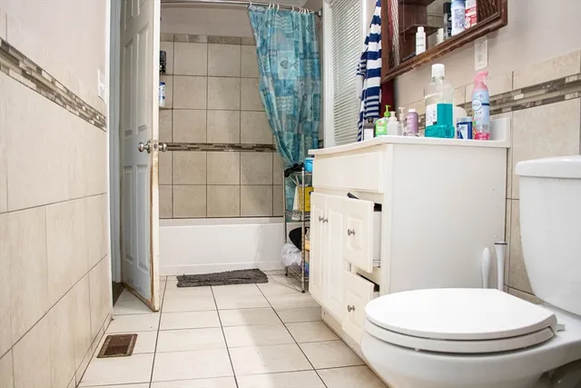 a white toilet sitting next to a bathroom sink