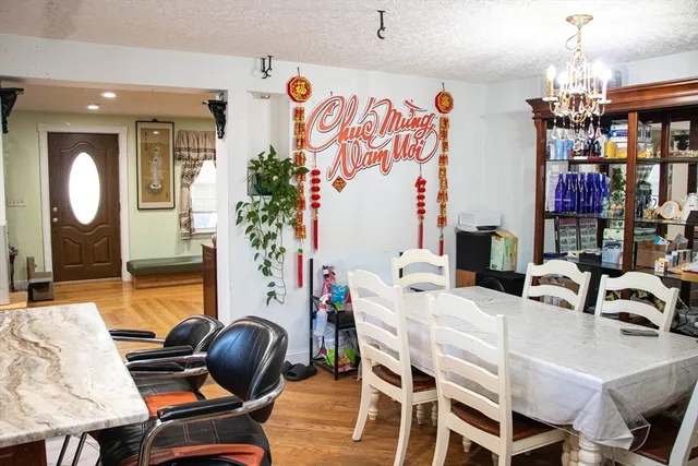 a dining room with furniture and wooden floor