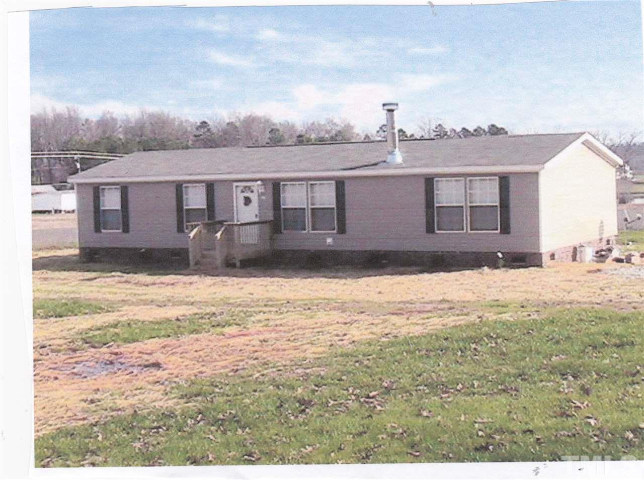 2279 Burlington Road Roxboro, NC 27574 - Photo 1 of 3 a view of a large house with a yard