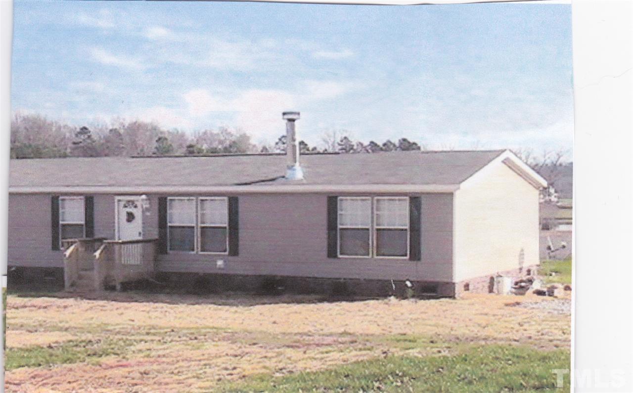 2279 Burlington Road Roxboro, NC 27574 - Photo 3 of 3 a front view of a house with a yard