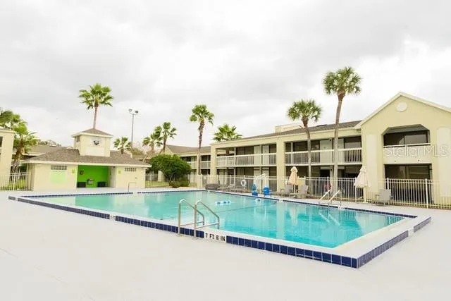 an aerial view of house with swimming pool and seating space