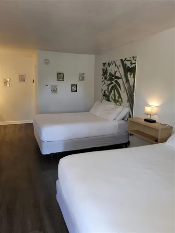 a bedroom with a bed and lamp