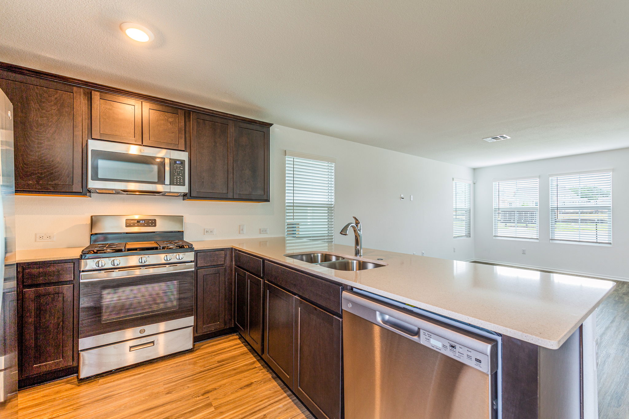 252 Patagonia Kyle, TX 78640 - Photo 11 of 30 a kitchen with stainless steel appliances granite countertop a sink stove and microwave