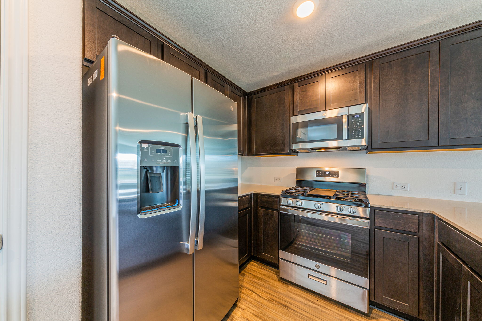 252 Patagonia Kyle, TX 78640 - Photo 12 of 30 a kitchen with stainless steel appliances a stove microwave and sink