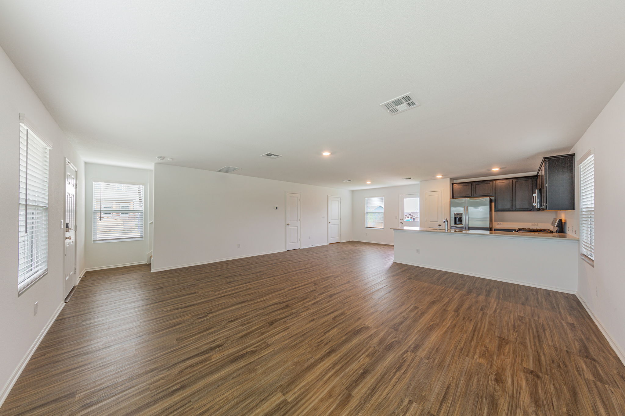 252 Patagonia Kyle, TX 78640 - Photo 6 of 30 a view of a kitchen with wooden floor and a window