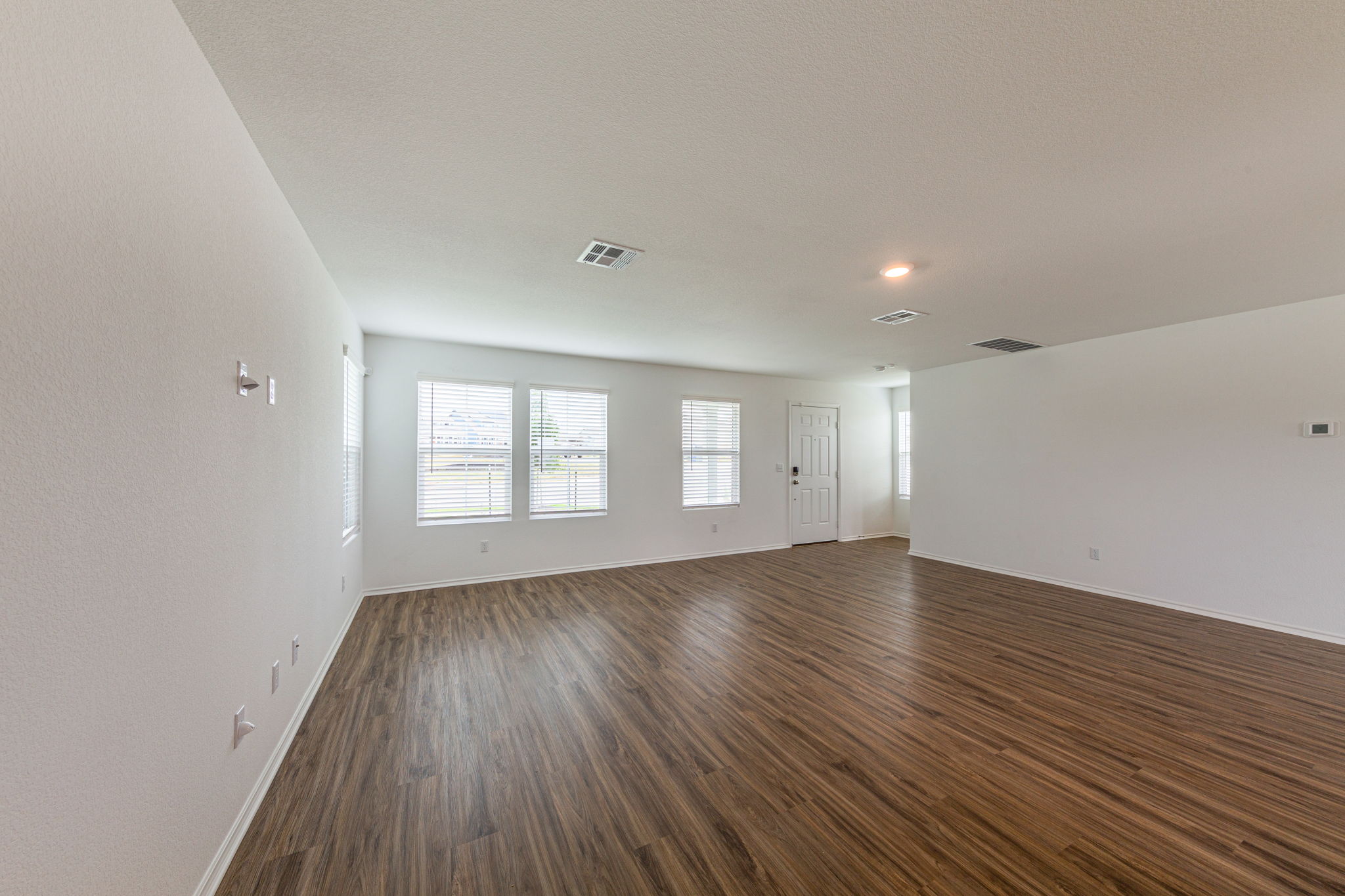 252 Patagonia Kyle, TX 78640 - Photo 7 of 30 an empty room with wooden floor and windows