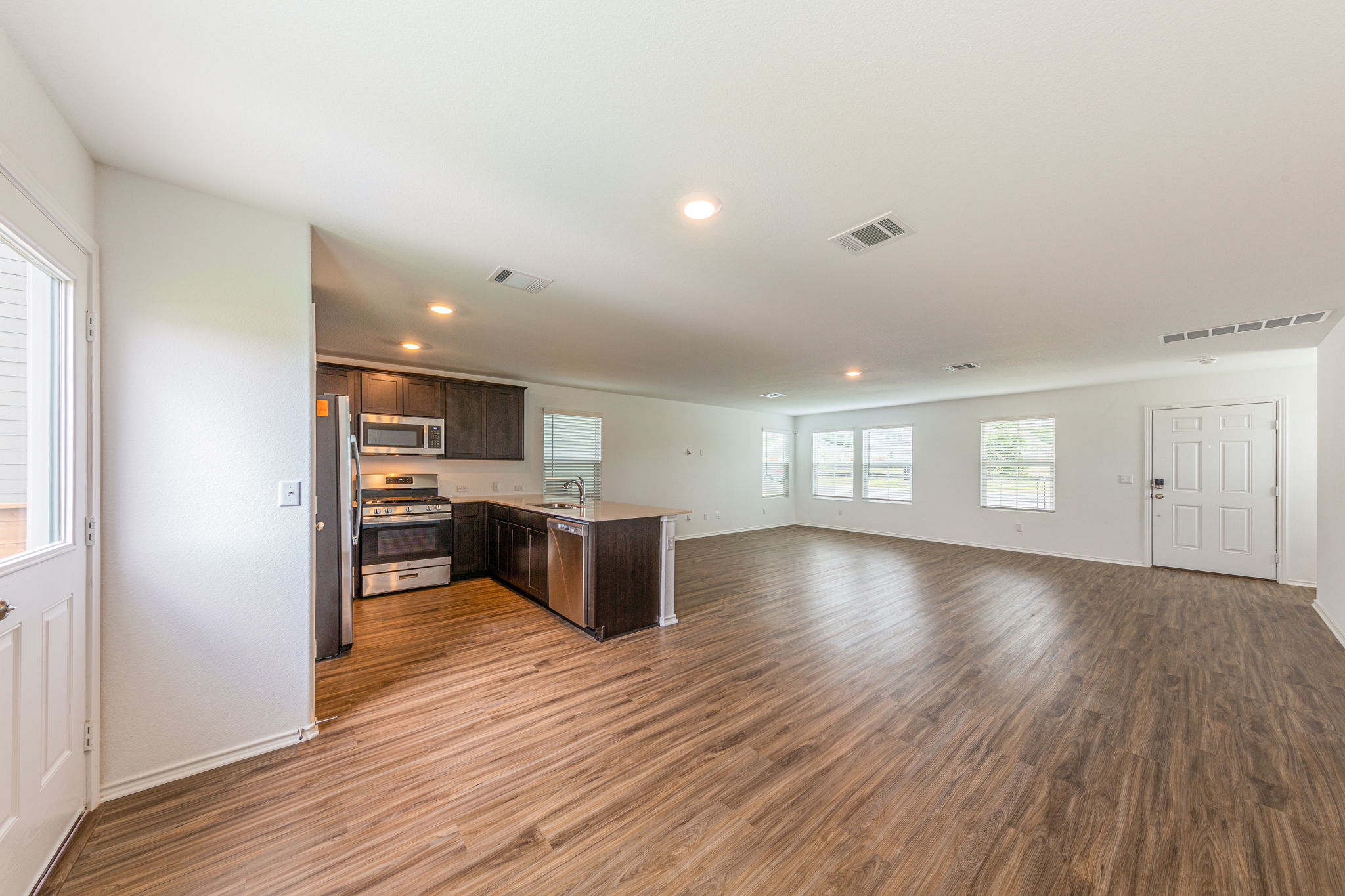 252 Patagonia Kyle, TX 78640 - Photo 9 of 30 a view of a livingroom with a kitchen and wooden floor