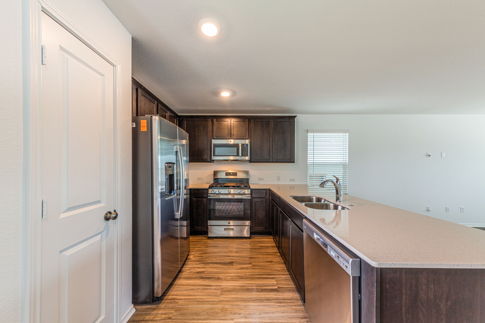 252 Patagonia Kyle, TX 78640 - Photo 10 of 30 a kitchen with stainless steel appliances granite countertop a sink and stove