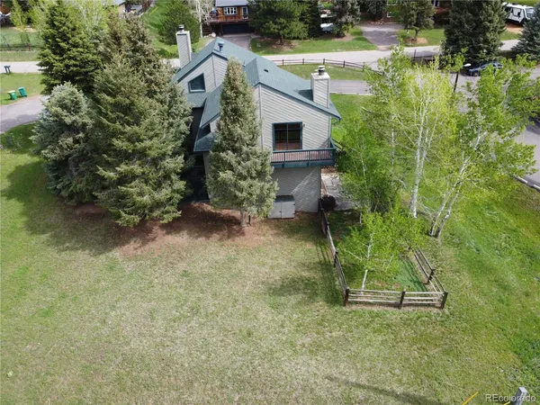 an aerial view of a house with a yard