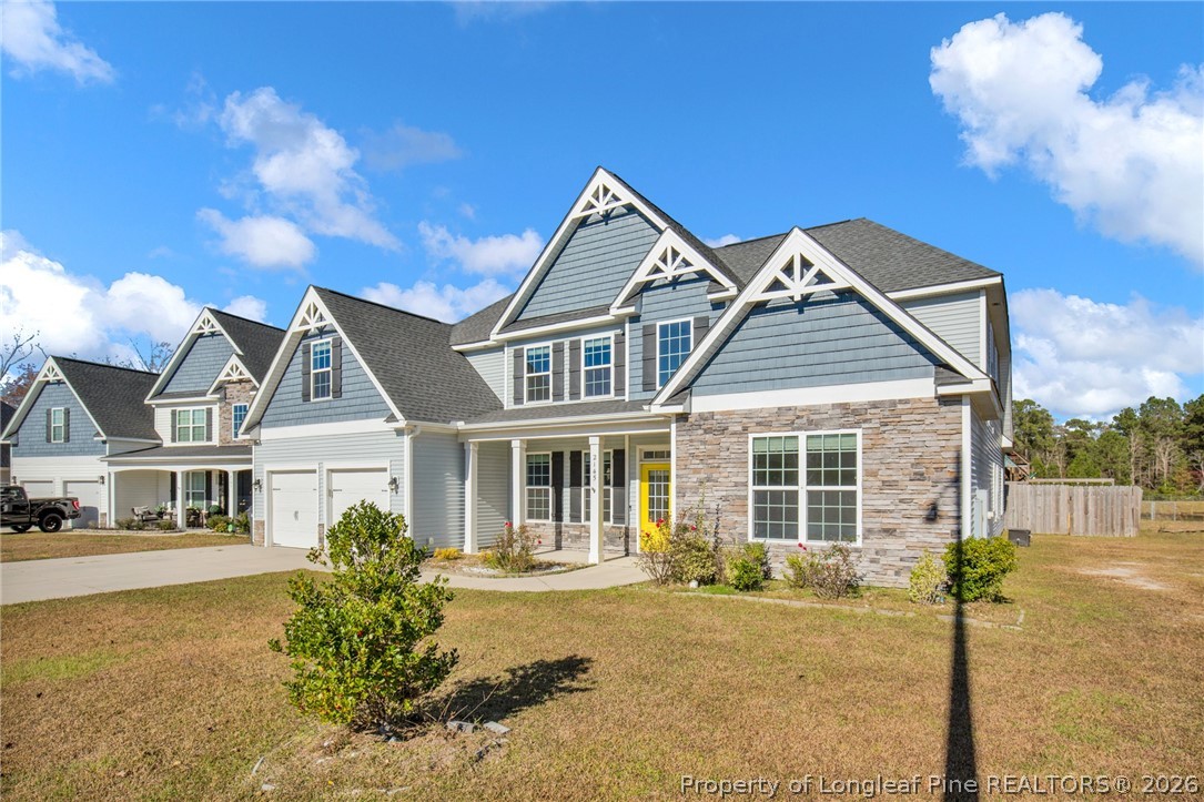 2145 Harrington Road Fayetteville, NC 28306 - Photo 4 of 50 a front view of a house with a garden and patio