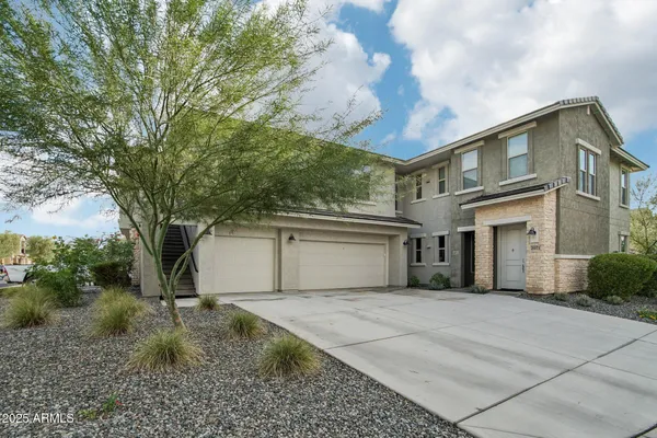 a front view of a house with a yard