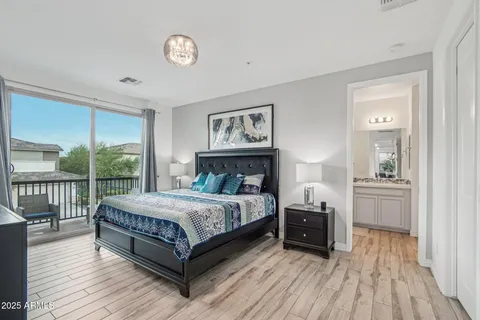a bedroom with a large bed and a wooden floor