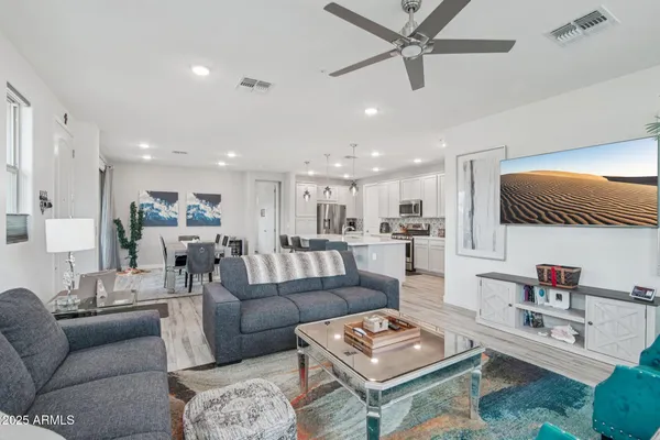 a living room with furniture kitchen view and a table