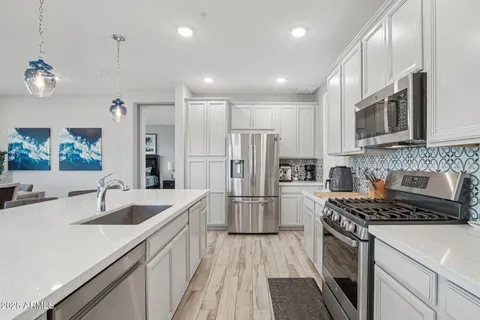 a kitchen with refrigerator and cabinets