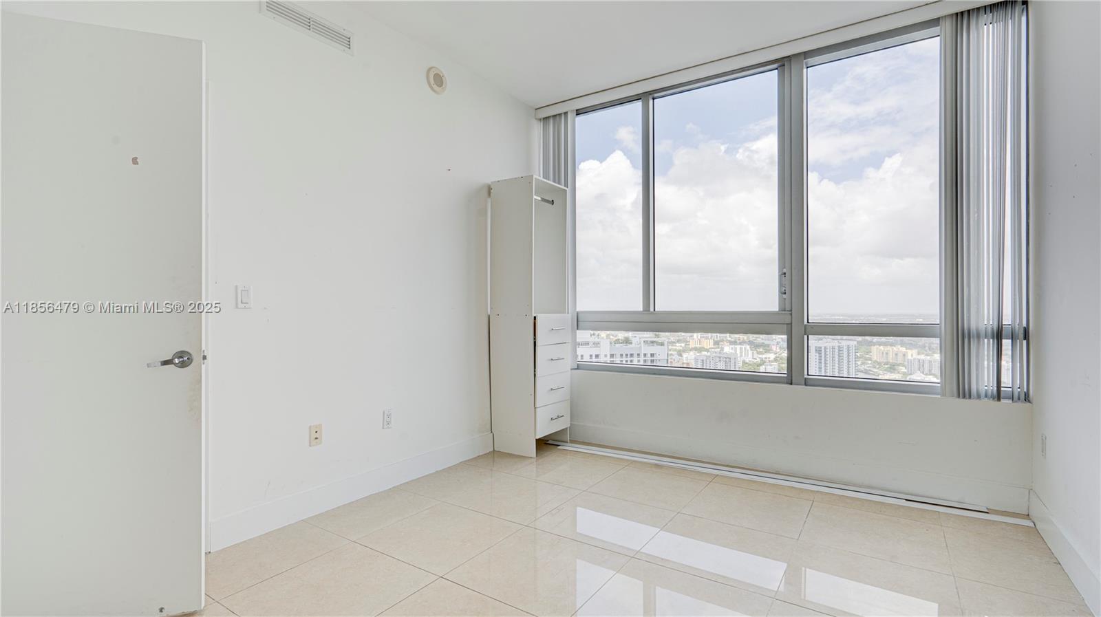 90 Southwest 3rd Street, Unit PH10 Miami, FL 33130 - Photo 12 of 23 a view of an empty room with a window