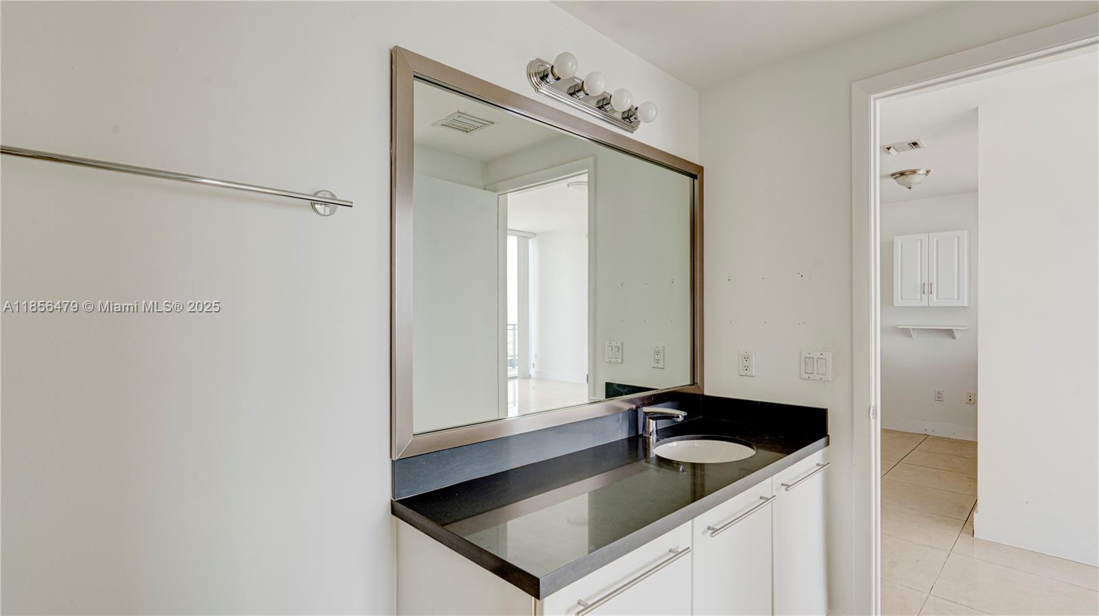 90 Southwest 3rd Street, Unit PH10 Miami, FL 33130 - Photo 14 of 23 a bathroom with a sink and a mirror