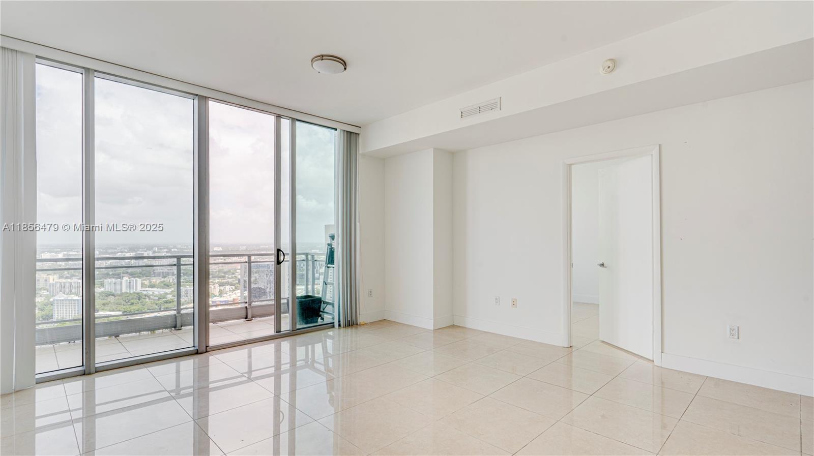 90 Southwest 3rd Street, Unit PH10 Miami, FL 33130 - Photo 3 of 23 a view of an empty room and window