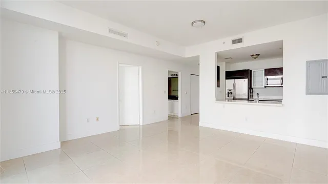a spacious bathroom with a double vanity sink a mirror and next to a window