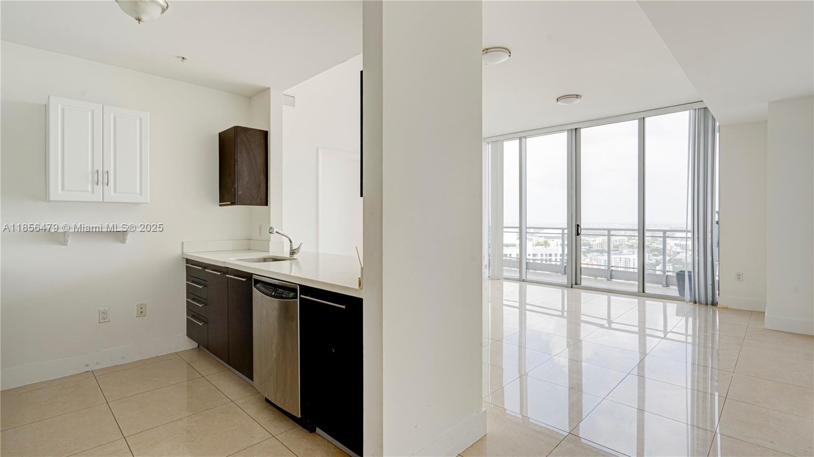 90 Southwest 3rd Street, Unit PH10 Miami, FL 33130 - Photo 5 of 23 a spacious bathroom with a double vanity sink a mirror and next to a window
