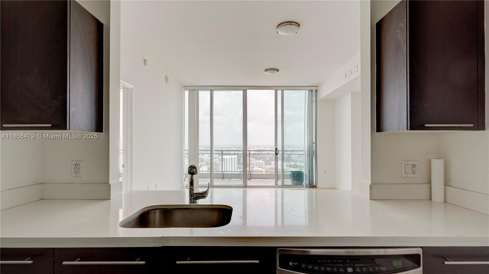 90 Southwest 3rd Street, Unit PH10 Miami, FL 33130 - Photo 10 of 23 a kitchen with a sink and cabinets