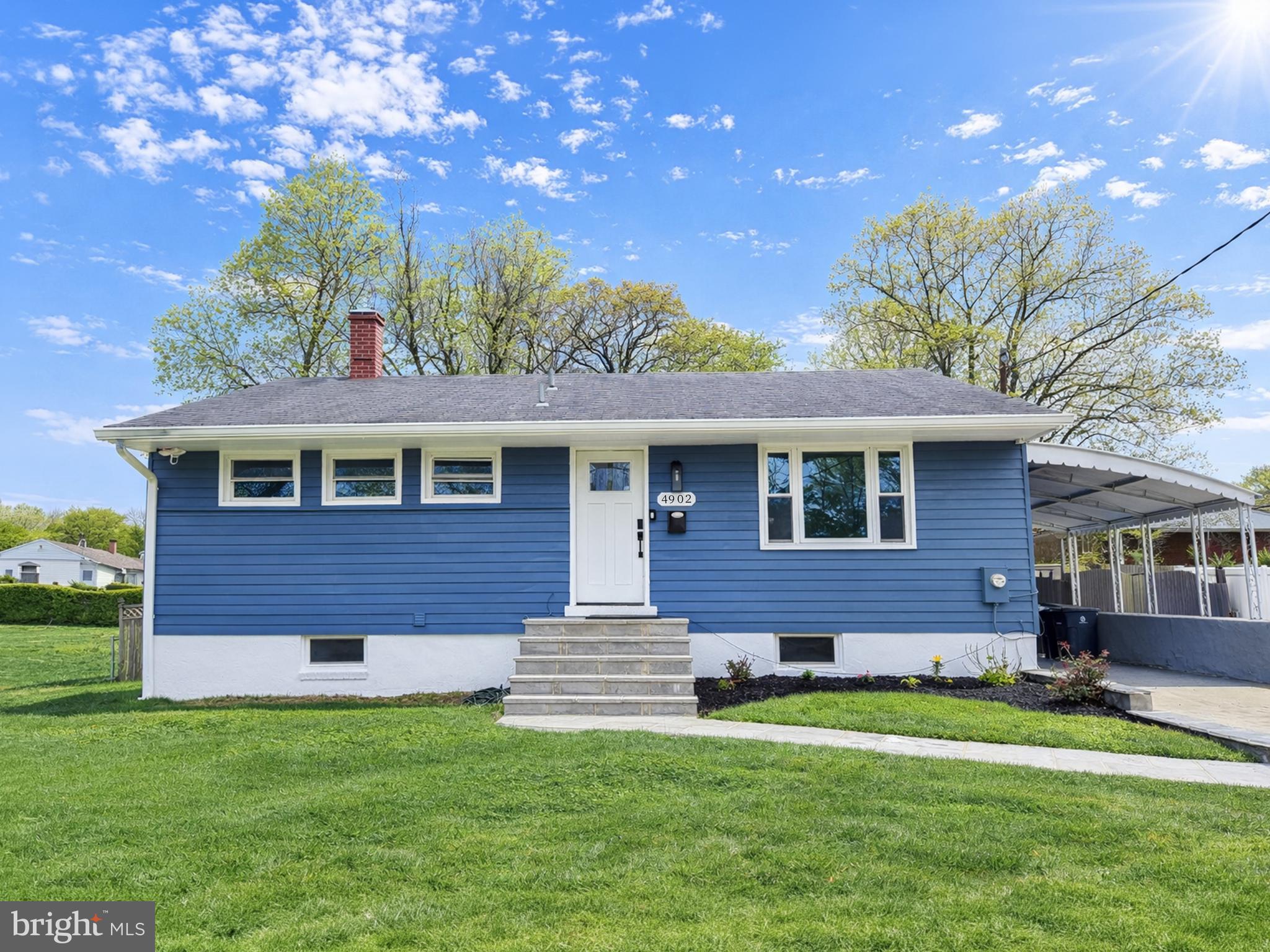 4902 91st Place Lanham, MD 20706 - Photo 1 of 30 a front view of a house with a garden