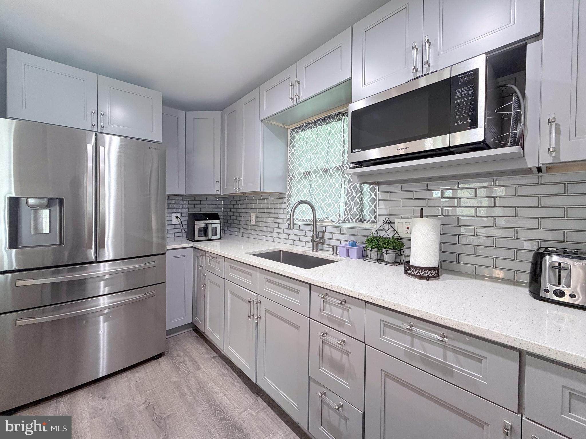 4902 91st Place Lanham, MD 20706 - Photo 13 of 30 a kitchen with appliances a sink and cabinets