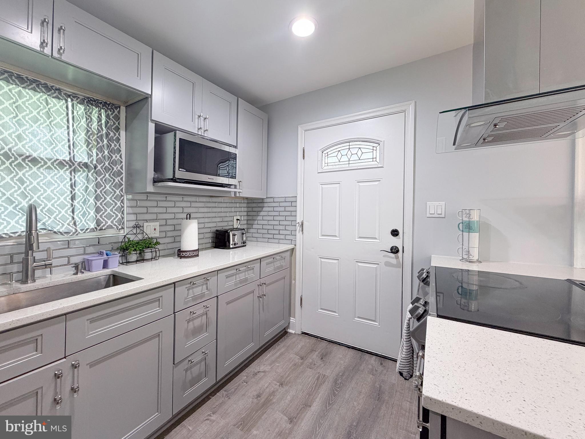 4902 91st Place Lanham, MD 20706 - Photo 15 of 30 a kitchen with cabinets and window