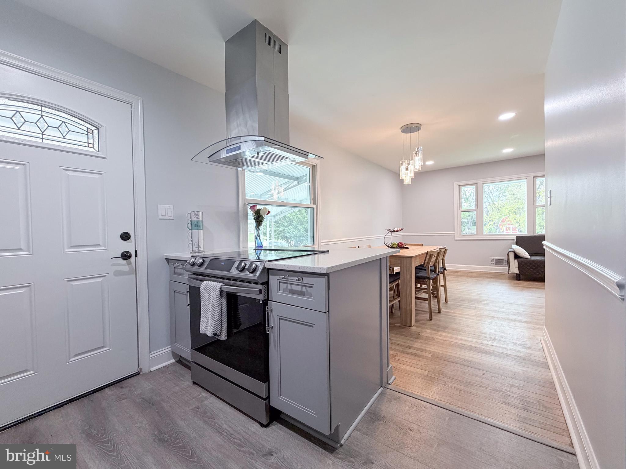 4902 91st Place Lanham, MD 20706 - Photo 16 of 30 a kitchen with stainless steel appliances granite countertop a stove top oven a sink and a refrigerator