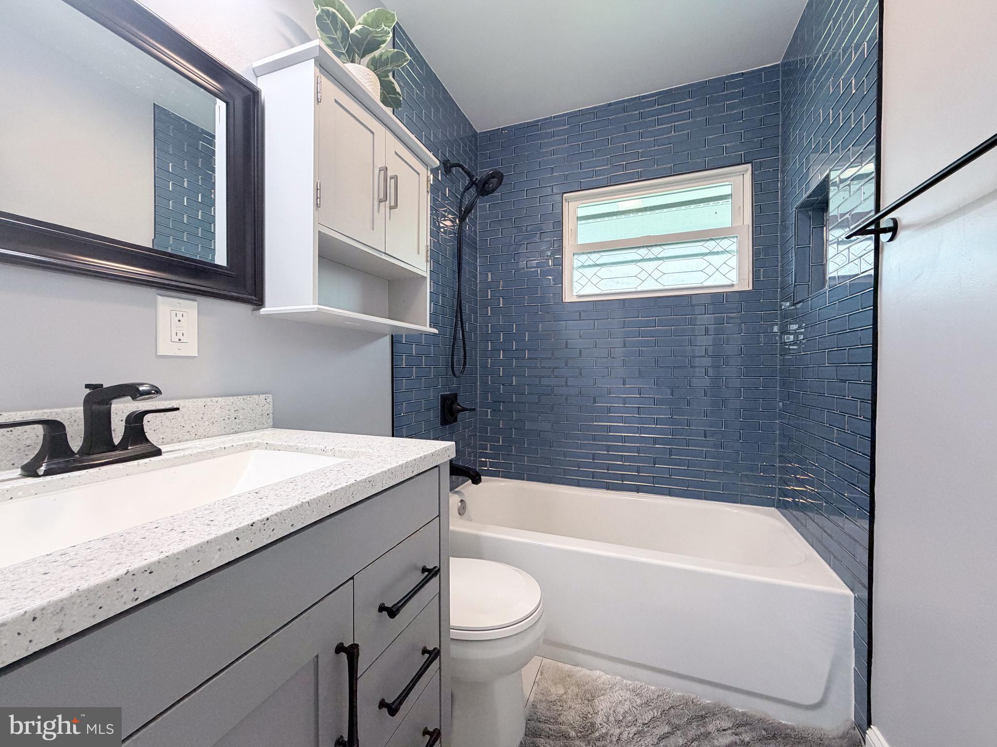 4902 91st Place Lanham, MD 20706 - Photo 17 of 30 a bathroom with a granite countertop sink toilet and bathtub