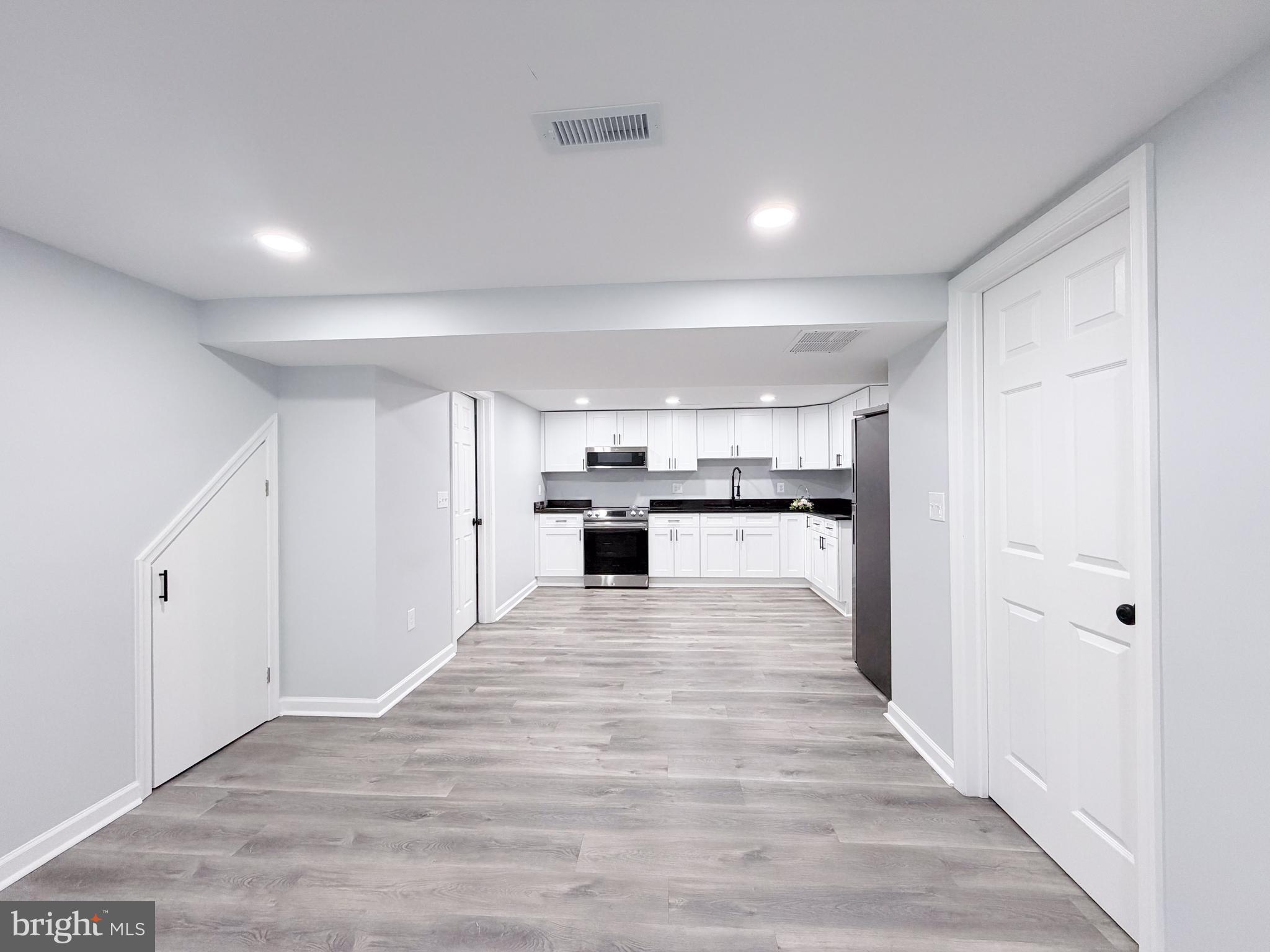 4902 91st Place Lanham, MD 20706 - Photo 19 of 30 a view of kitchen with wooden floor