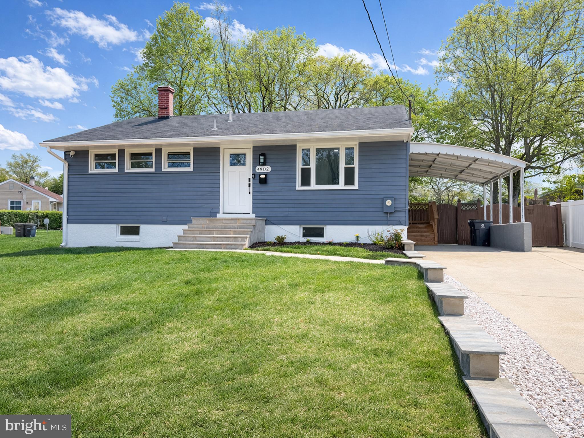 4902 91st Place Lanham, MD 20706 - Photo 2 of 30 a front view of a house with a yard
