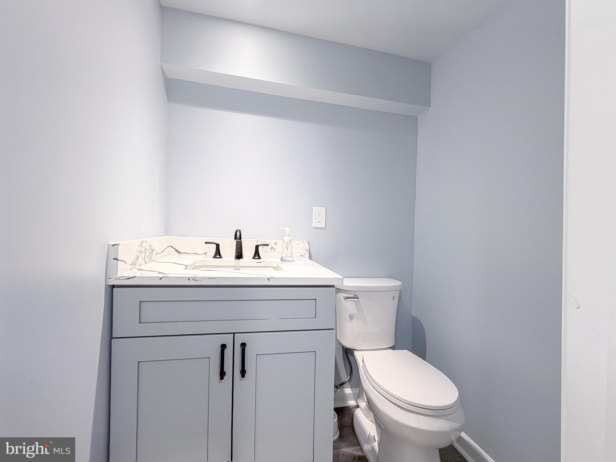 4902 91st Place Lanham, MD 20706 - Photo 25 of 30 a bathroom with a sink toilet and a mirror
