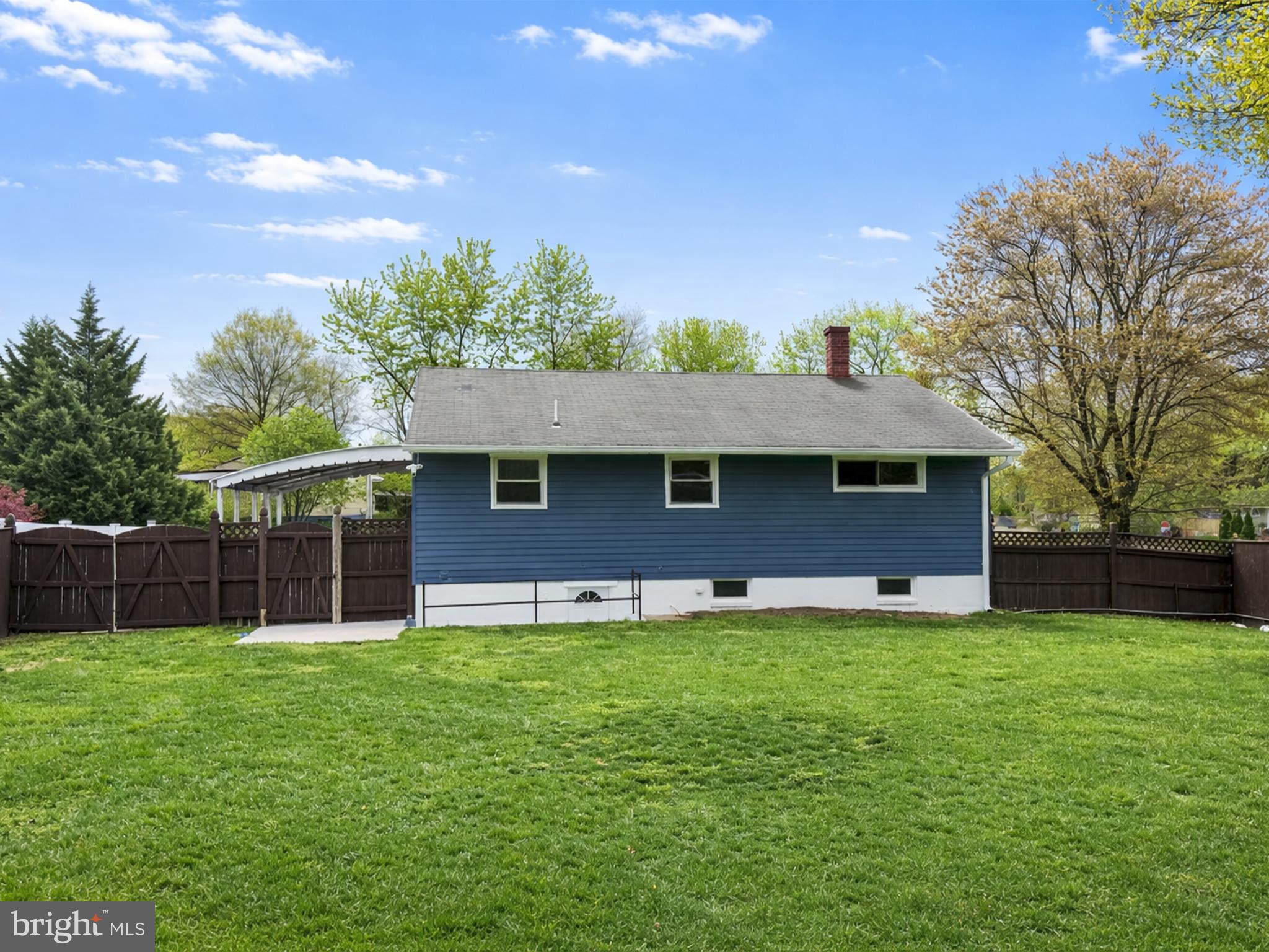 4902 91st Place Lanham, MD 20706 - Photo 6 of 30 a front view of a house with a yard