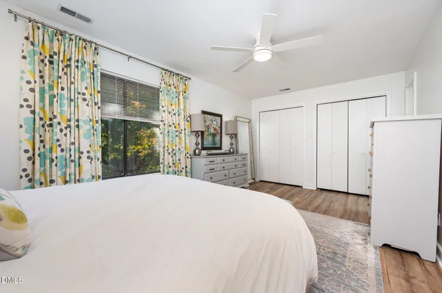 a spacious bedroom with a bed and a cabinets