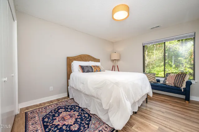 a bedroom with a bed and a window