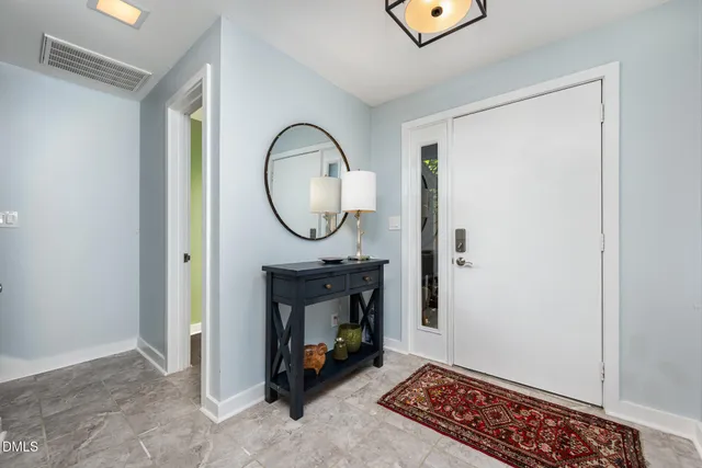 a view of living room with furniture and a mirror